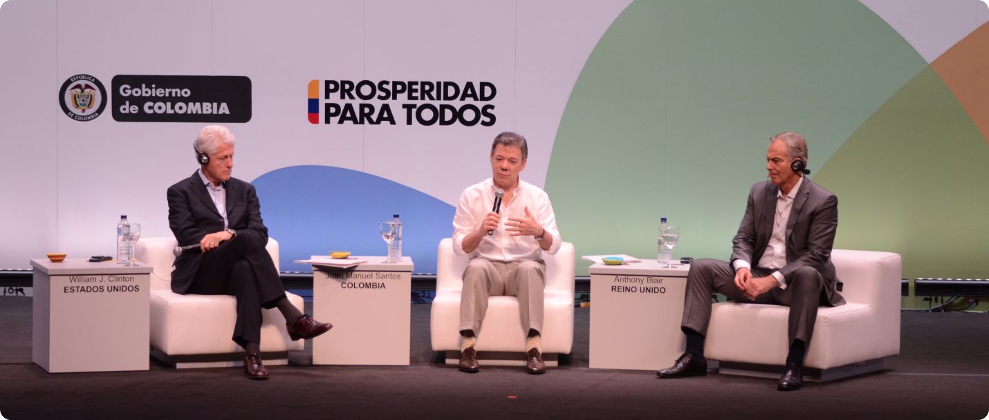 Santos speaks while Clinton and Blair listen to simultaneous interpretation into English at a conference in Cartagena, Colombia